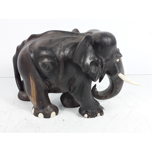 136 - Carved hardwood figure of an elephant, 15cms in height