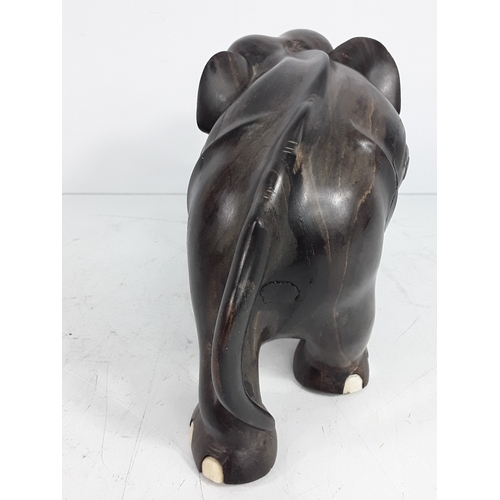 136 - Carved hardwood figure of an elephant, 15cms in height