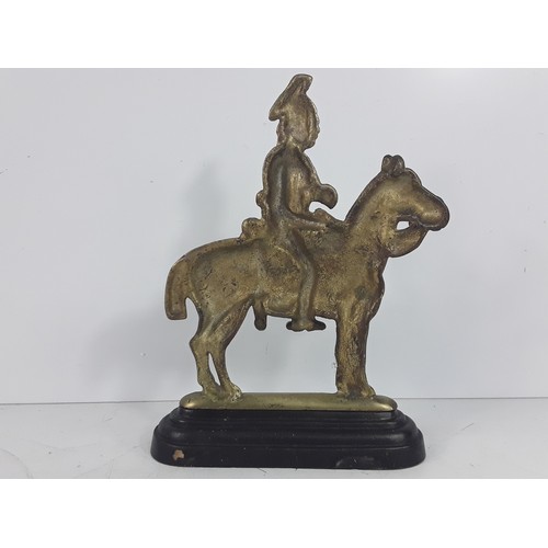 125 - Victorian brass Hussar doorstop and a brass Crown believed to be from the Post Office