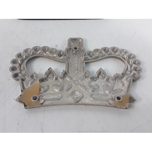 125 - Victorian brass Hussar doorstop and a brass Crown believed to be from the Post Office