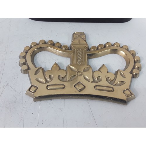 125 - Victorian brass Hussar doorstop and a brass Crown believed to be from the Post Office
