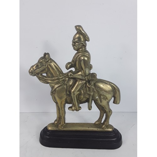 125 - Victorian brass Hussar doorstop and a brass Crown believed to be from the Post Office
