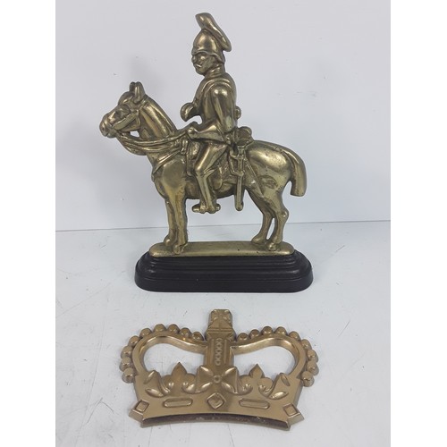 125 - Victorian brass Hussar doorstop and a brass Crown believed to be from the Post Office