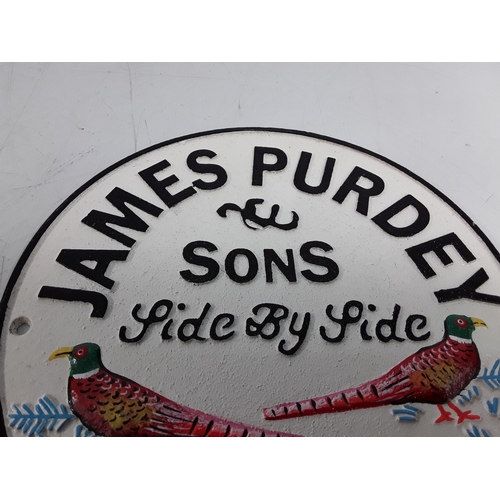 40 - Cast metal James Purdey advertising sign, 24cms in diameter