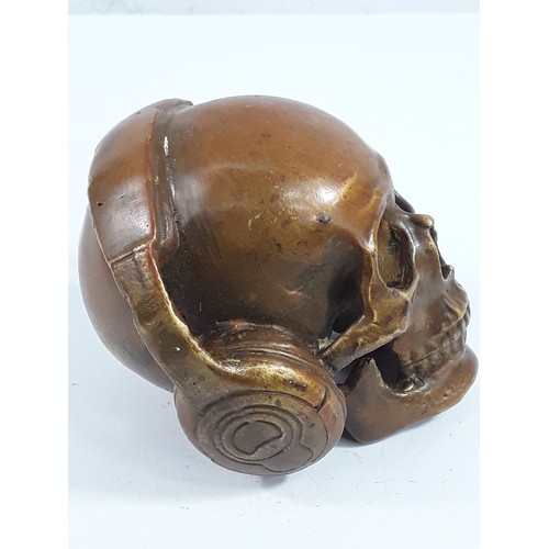 23 - Cast bronze skull and headphones, 8 x 10 x 10cms
