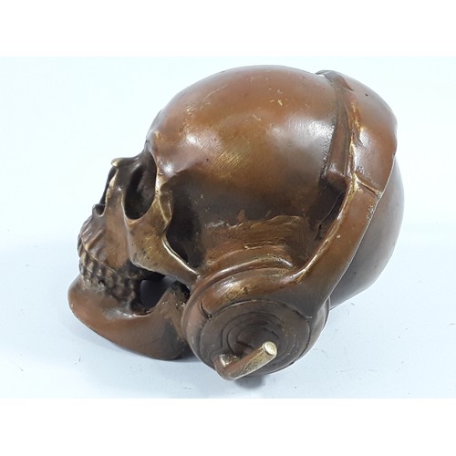 23 - Cast bronze skull and headphones, 8 x 10 x 10cms