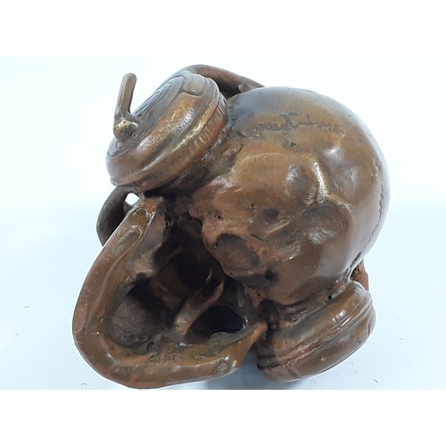 23 - Cast bronze skull and headphones, 8 x 10 x 10cms