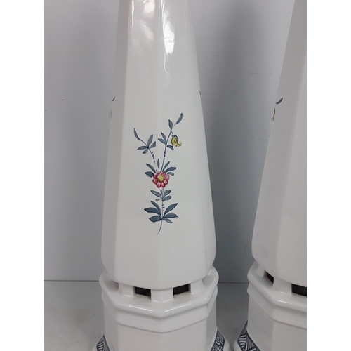 30 - A pair of Italian porcelain obelisks with floral pattern, signed by Ian Lewis