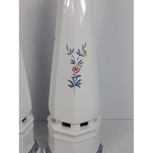 30 - A pair of Italian porcelain obelisks with floral pattern, signed by Ian Lewis