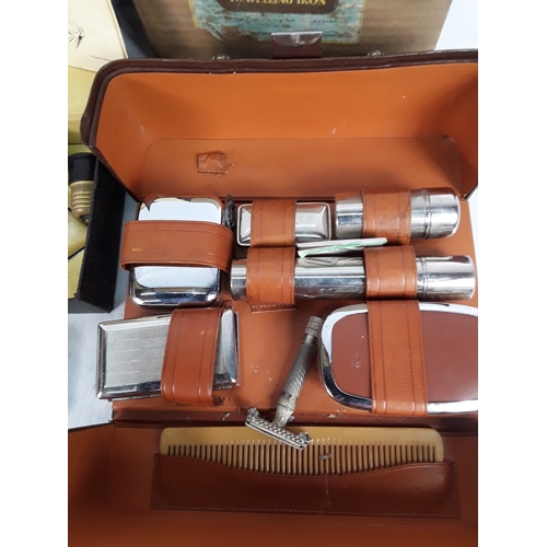 173 - Travelling iron, vanity set and razor stroop