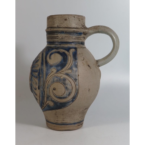 423 - A Westerwald Pottery Jug with incised decoration and initials GR, 23cm