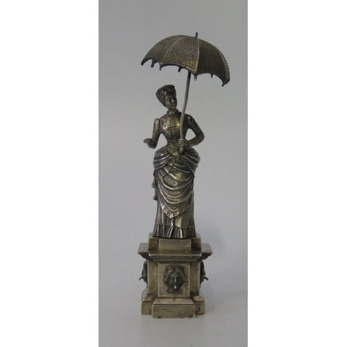 75 - A Continental Silver Figurine of a Lady with Parasol standing on a plinth with mask fountains, penta... 