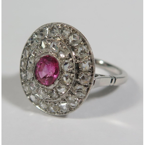 230a - A Ruby and Rose Cut Diamond Cluster Ring in a precious white metal setting, 20 x 17mm spread, size M... 