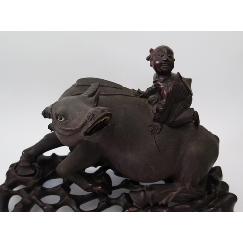 458 - A Nineteenth Chinese Carving of a Recumbent Water Buffalo with laughing figure on back and on a carv... 