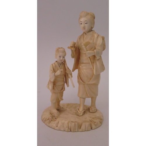 461a - A Japanese Ivory Okimono depicting lady with child, signature to base, 15cm high