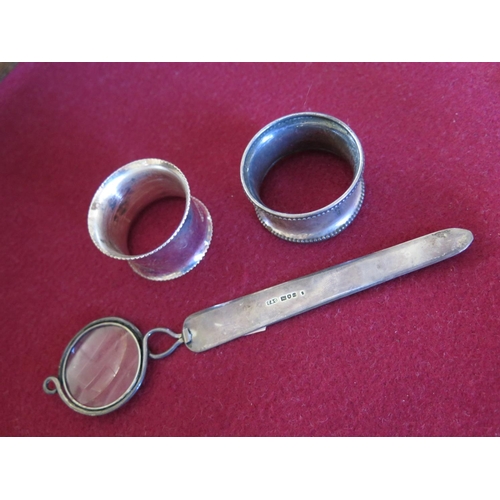 30 - An Edward VII Silver Combination Magnifying Glass Paper Knife and two napkin rings