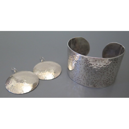 36b - A Planished Silver Bangle and pair of matching earrings