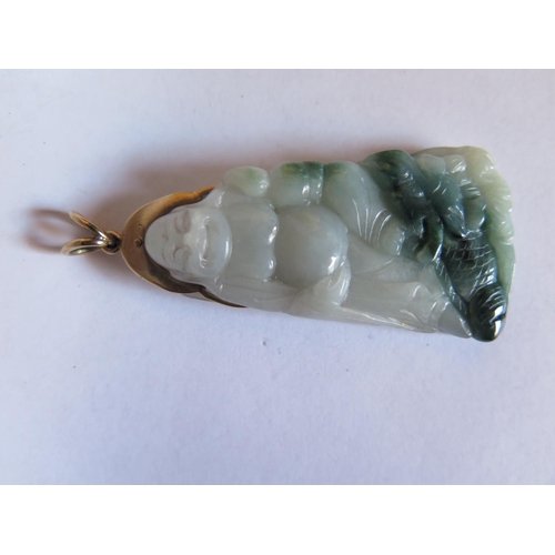 45e - A Chinese Carved Jadeite  Pendant depicting Buddha on a yellow metal mount, 66mm drop