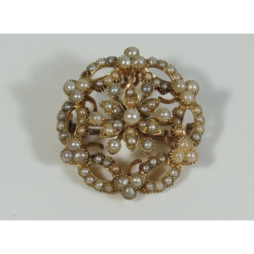 317 - A Seed Pearl Brooch with hinged pendant loop in a 15ct gold setting, 25mm diam.