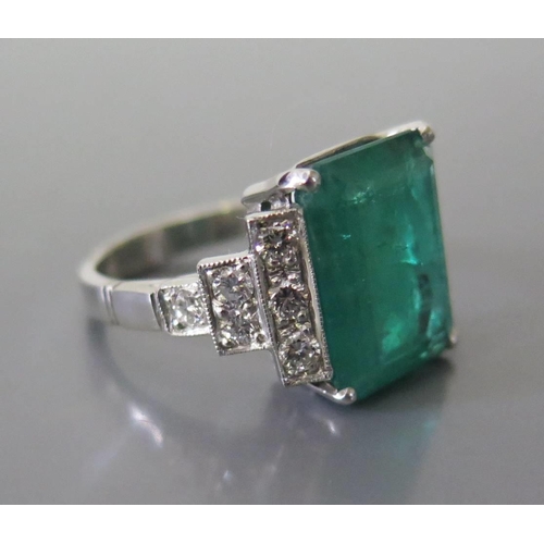 322 - An Art Deco Style Emerald and Diamond Ring in a precious white metal setting, size N, 10.8g. Emerald... 