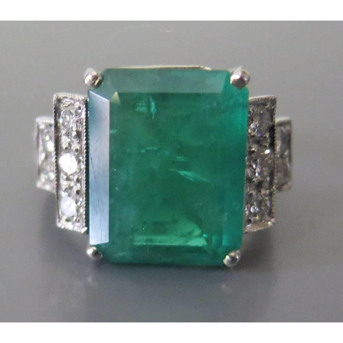 322 - An Art Deco Style Emerald and Diamond Ring in a precious white metal setting, size N, 10.8g. Emerald... 