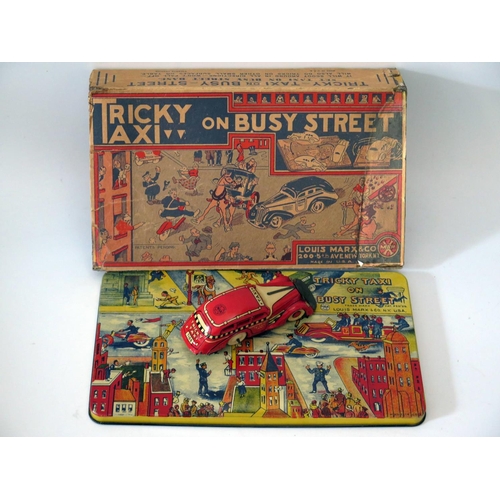 509 - Tin Plate Toy _ A Marx Tricky Taxi on busy street. Manufactured in 1935 and complete with box