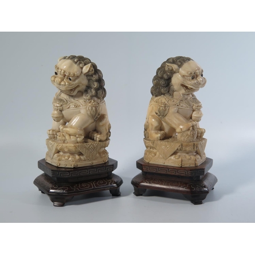 532 - A Pair of Chinese Carved Ivory Shishi on inlaid wooden stands, early 20th century, 14cm Both lots 53... 