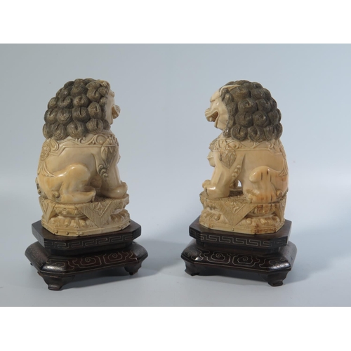 532 - A Pair of Chinese Carved Ivory Shishi on inlaid wooden stands, early 20th century, 14cm Both lots 53... 