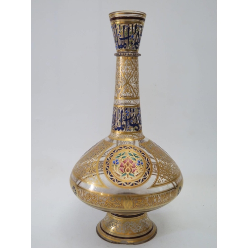 589 - An Islamic Glass Vase decorated in enamels and gilt with script and stylised flowers, the base marke... 