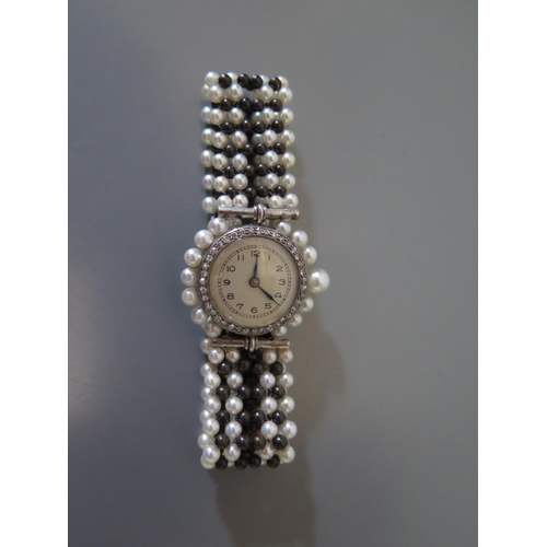187 - A Diamond Mounted Evening Watch with pearl strap
