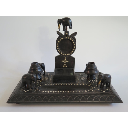 288 - An Indian Ebony Desk Stand with elephant finials