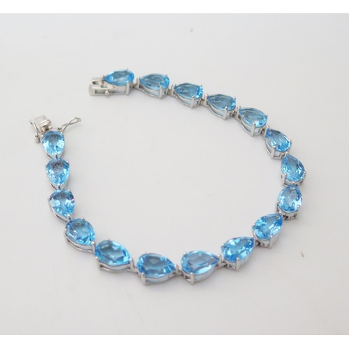 164 - A 14K White Gold and Blue Topaz Bracelet, c. 18.5cm, 14.1g