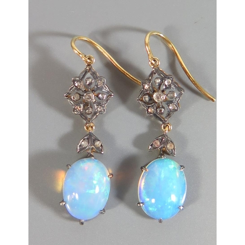 174 - A Pair of White Opal and Diamond Earrings in a precious yellow metal setting, c. 32mm drop, 3.7g