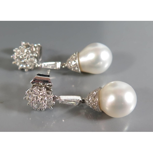 177 - A Pair of 18ct White Gold Pearl and Diamond Pendant Earrings, 32/34mm drop, (EDW 1.62ct) 8.1g