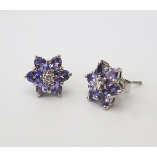 181 - A Pair of 18ct White Gold, Tanzanite and Diamond Flower Head Stud Earrings, c. 12mm diam., 3.8g