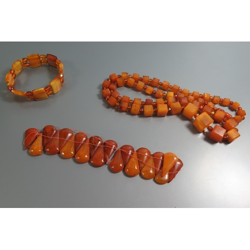 211 - A Graduated Square Amber Bead Necklace and Bracelets, largest square bead c. 10mm, 71.8g