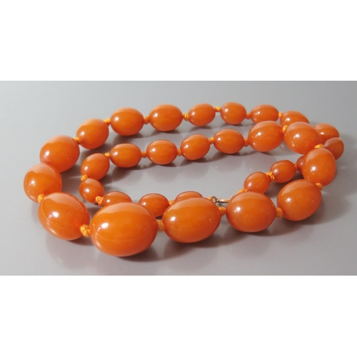 212 - A Graduated Amber Bead Necklace, largest bead c. 25 x 20mm, 51.4g (pos. pressed resin)