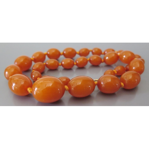 212 - A Graduated Amber Bead Necklace, largest bead c. 25 x 20mm, 51.4g (pos. pressed resin)