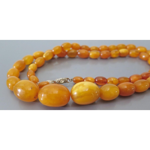 215a - A Butterscotch Amber Bead Necklace 42.9g (largest bead c. 22 x 16mm) AND bracelet 7.5g