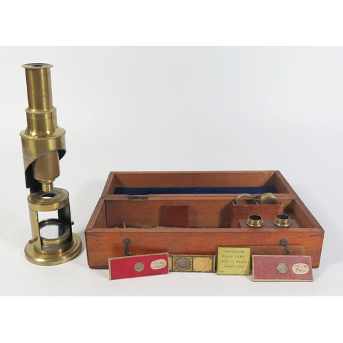 302c - A Small Nineteenth Century Brass Microscope in fitted case and with slides, 17.5cm