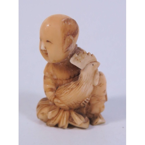 362a - An Antique Japanese Ivory Netsuke of a seated figure holding cockerel UK BIDS ONLY