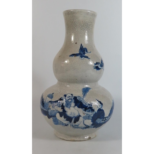 381 - An Oriental Blue and White Porcelain Crackle Glazed Vase of double gourd form decorated with a shall... 