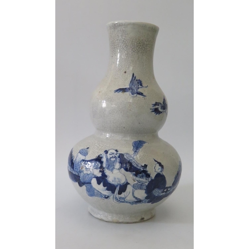 381 - An Oriental Blue and White Porcelain Crackle Glazed Vase of double gourd form decorated with a shall... 