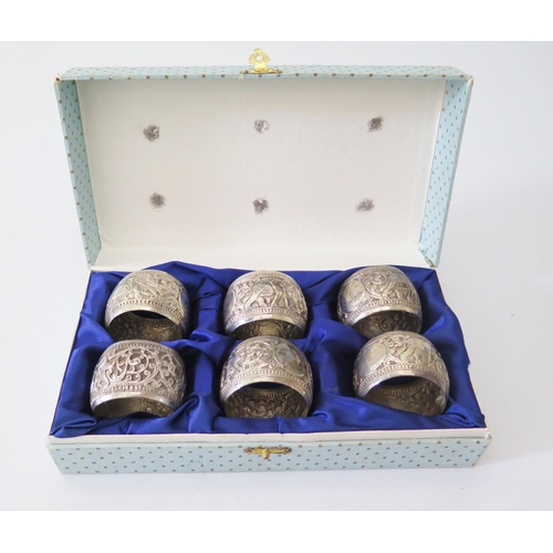 6a - A Set of Six Indian Silver Napkin Rings decorated with elephants and scrolling foliate work, 120g