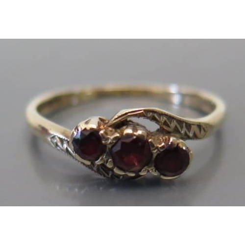 107 - A 9 carat gold and garnet 3 stone ring