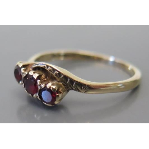 107 - A 9 carat gold and garnet 3 stone ring