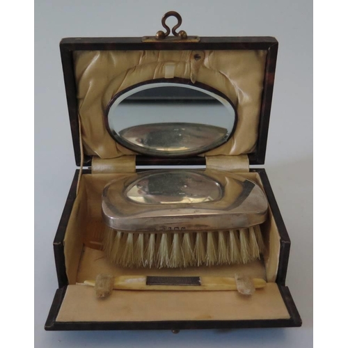 28 - A cased silver backed brush with mirror
