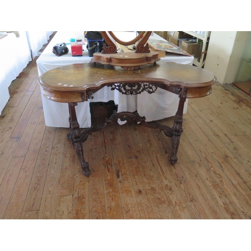 500 - A Victorian kidney shaped dressing table with heavily carved decoration and seaweed marquetry