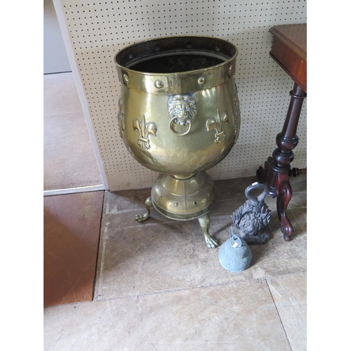 521 - A large brass cauldron on integral stand