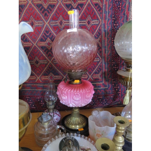 580 - A Victorian oil lamp with pink glass Reservoir